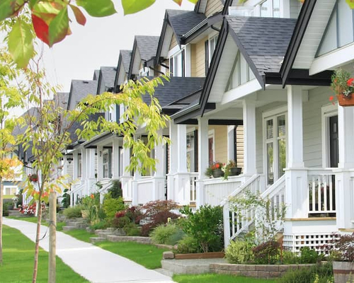White condos with small porches, depicting a residential complex or condominiums.
