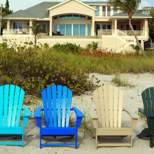 Possibly a beach house with chairs on beach facing the ocean indicating a property intended for investment purposes.