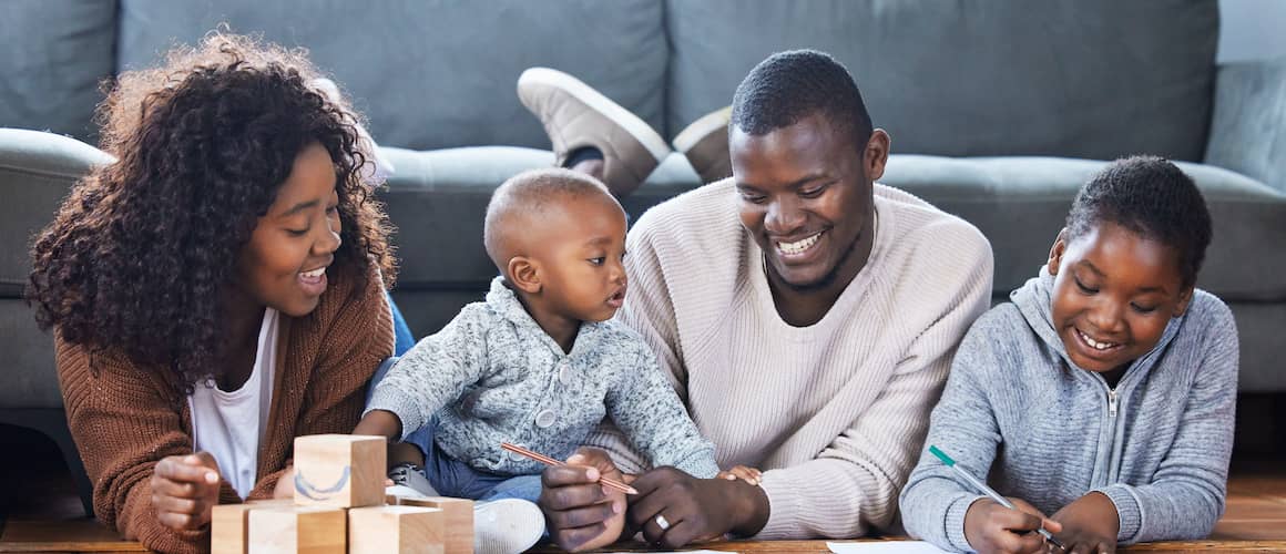 A family playing together in the lounge at home, showing family bonding and leisure time.