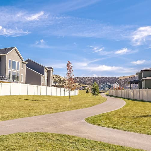 Fork in two sidewalks through a residential neighborhood.