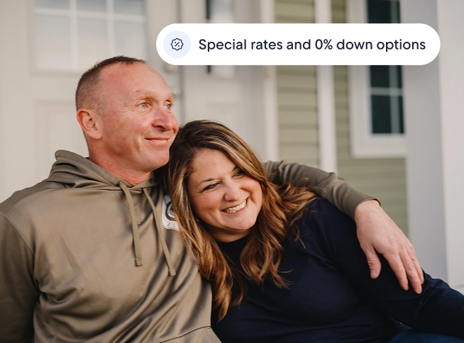 Smiling couple sitting together on their front steps, with text reading "Special rates and 0% down options."