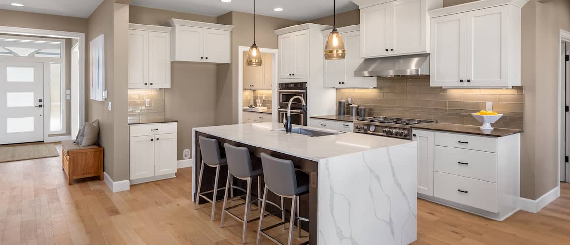 RHB Assets From IGX: Luxury kitchen with white marble countertops and stainless steel appliances.