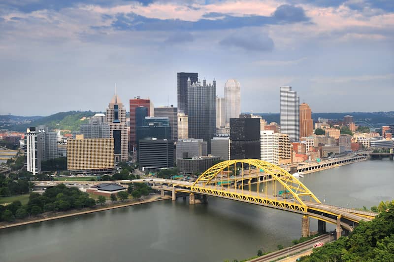 RHB Assets From IGX: Pittsburgh skyline during daytime with a view of the river and bridges.