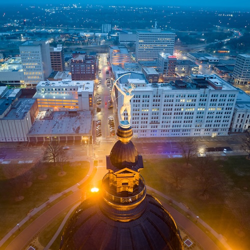 Night-time aerial view of Topeka, Kansas, with the Ad Astra statue in the forefront.