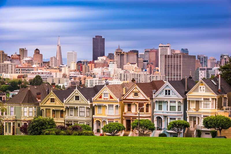 RHB Assets From IGX: A row of Victorian homes with the San Francisco skyline in the background.