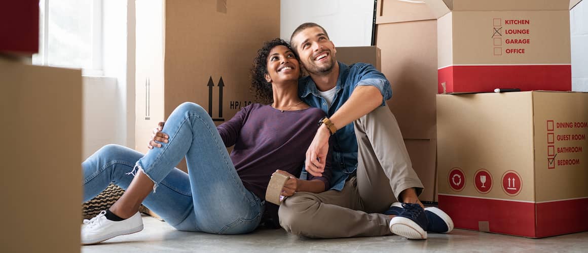 A couple moving into a new home, symbolizing the process of relocation and homeownership.