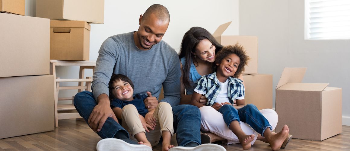 A family moving into a new home, symbolizing the transition and excitement of relocating.