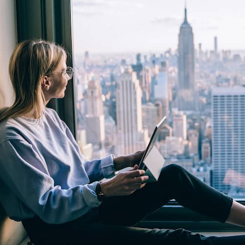 Woman looking at city out window.