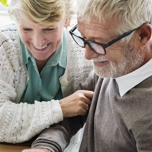 An older couple enjoying lunch together, potentially depicting retirement or leisure time at home.