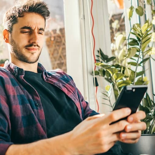Man looking at smart phone.