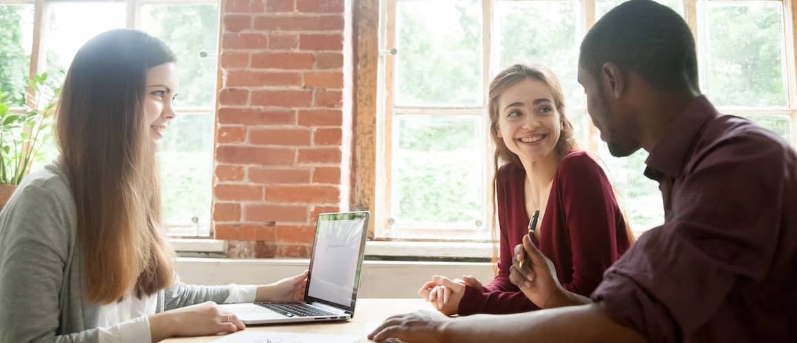 Couple chatting with financial advisor. 