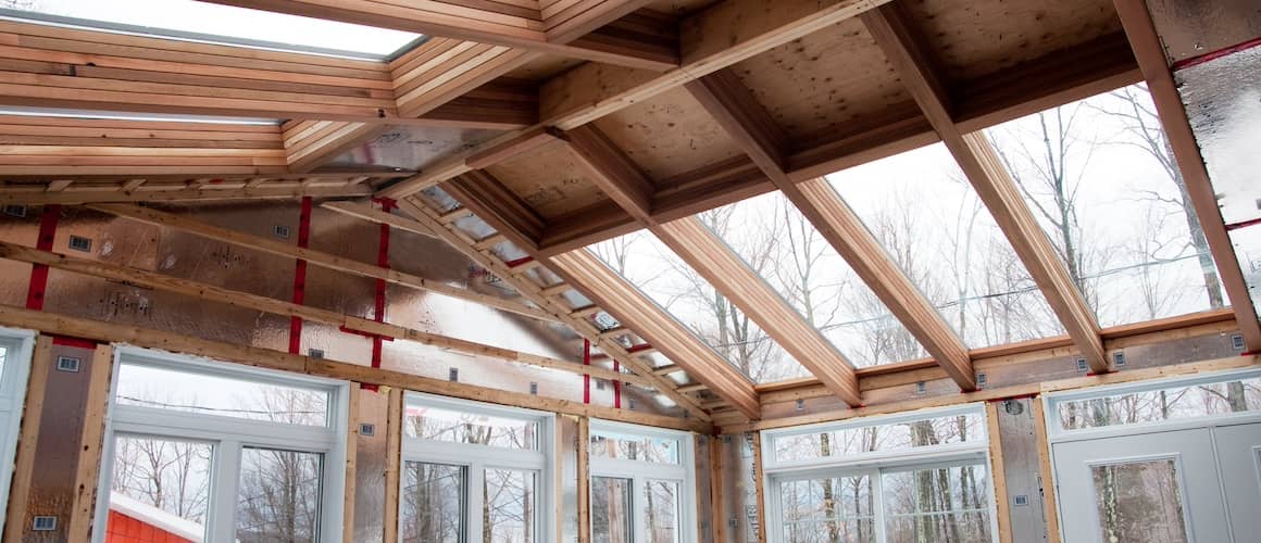 Large sunroom under construction during winter.