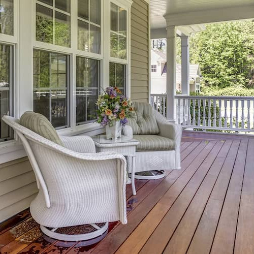 A country-style home with a wrap-around deck, showcasing its exterior and architectural design.