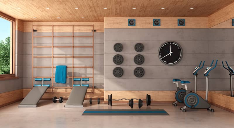 RHB Assets From IGX: Home gym setup in a garage conversion with exercise equipment.