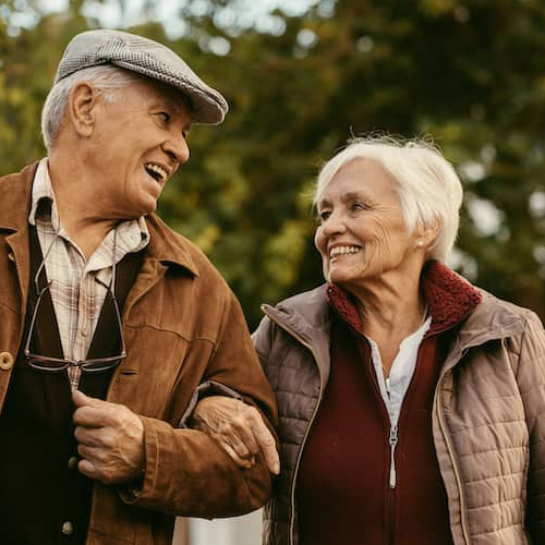 A senior couple enjoying a walk together.
