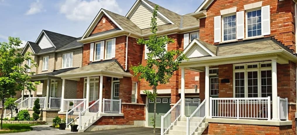 A row of residential houses, showcasing a neighborhood or housing development.