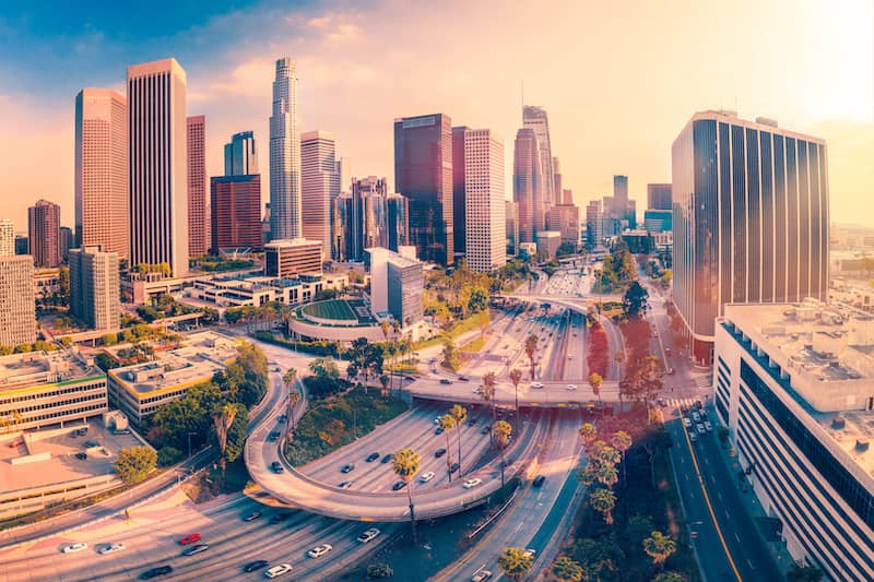 RHB Assets From IGX: Aerial view of Los Angeles with skyscrapers and highways.