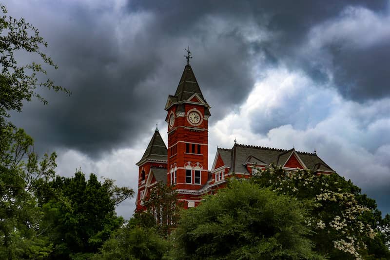 RHB Assets From IGX: Auburn University's iconic Samford Hall in Auburn, Alabama with its clock tower and lush surroundings.