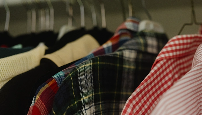Shirts hanging up in closet.