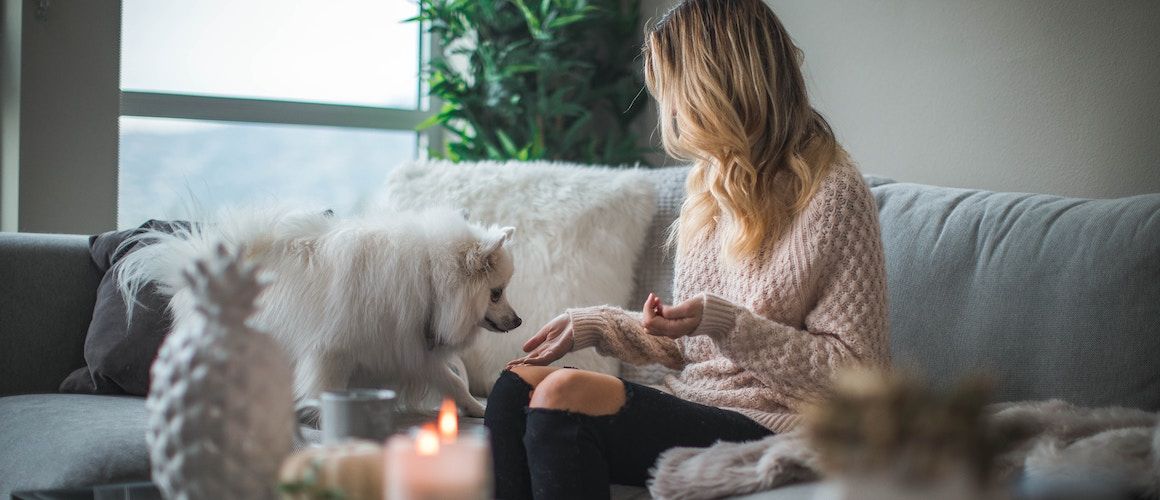 A woman with a dog, depicting a homeowner or tenant with a pet, potentially discussing pet-friendly housing or home-related topics.