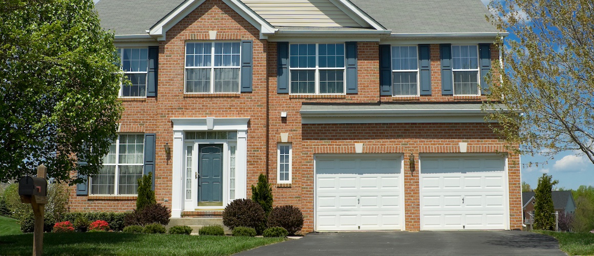 Brick two-story single-family home with attached double garage.