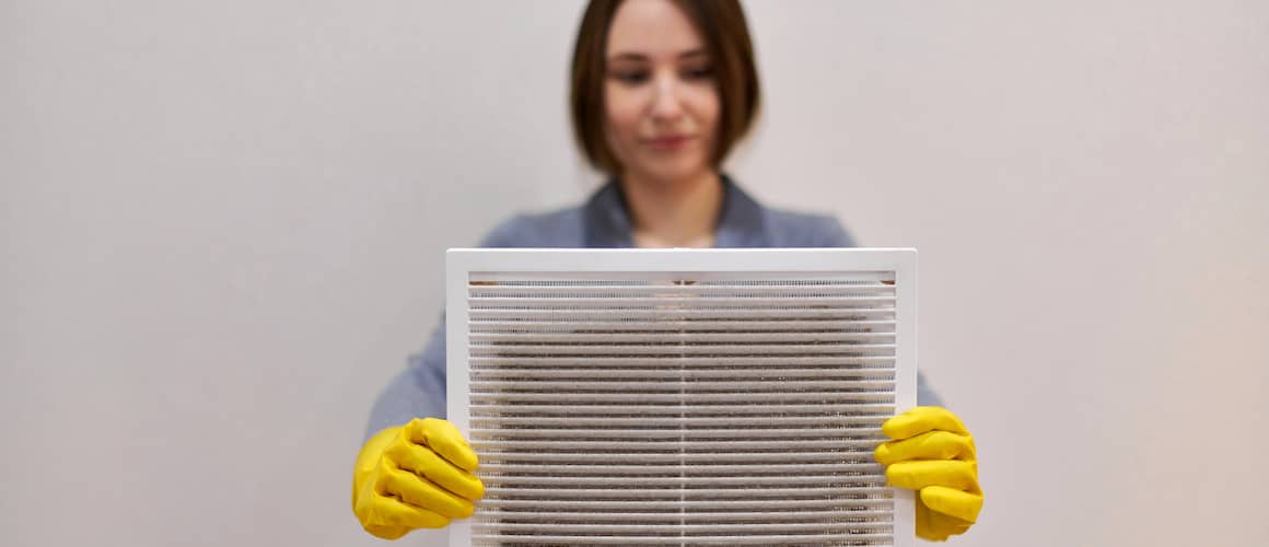 RHB Assets From IGX: A woman holding a dirty air filter.