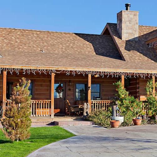 The entrance to a brown ranch-style home, depicting a property's entrance or exterior.