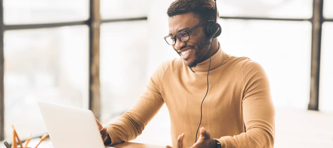 A man wearing a headset, likely in a customer service or financial services role.