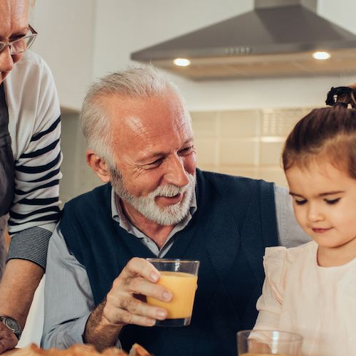 Grandparents enjoying breakfast together, portraying family moments in a home setting.