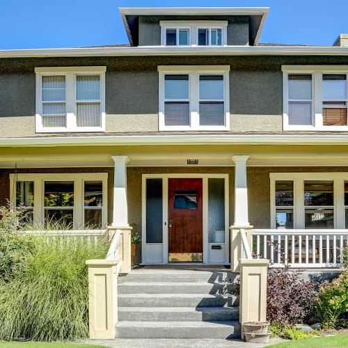 The front of a rural two story house.