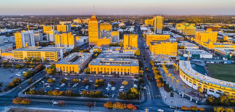 RHB Assets From IGX: Fresno, California street scene with palm trees and city buildings