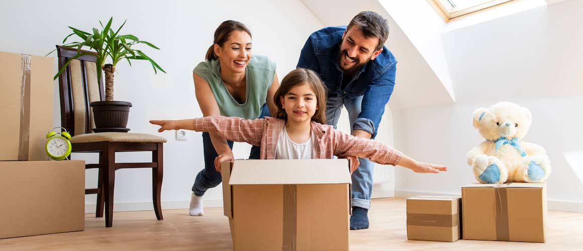 Young couple moving into new home with their daughter.