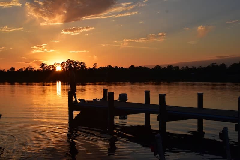 RHB Assets From IGX: Sunset view of Milton, Florida, a small town with a river.