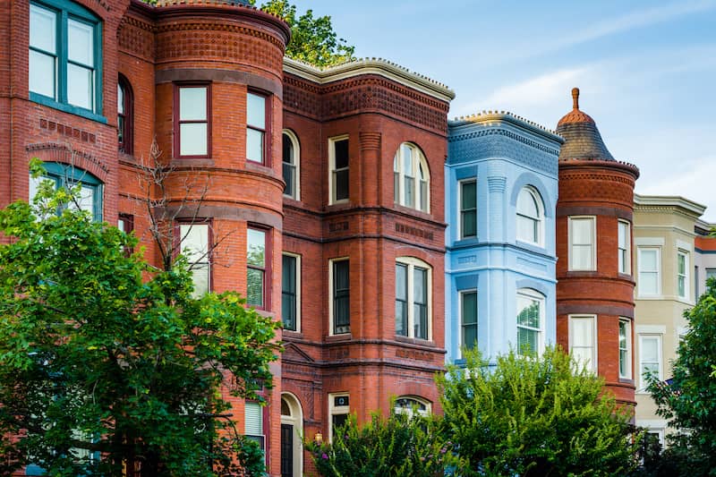 RHB Assets From IGX: Old brick apartment buildings in Washington, DC with blue and red facades