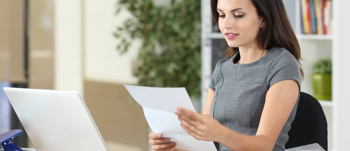 A woman filing papers, potentially related to mortgage or financial documentation.