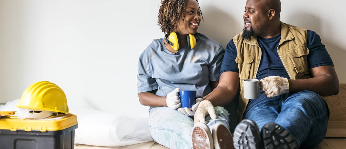 Image of man and woman taking a coffee break during home improvement project.