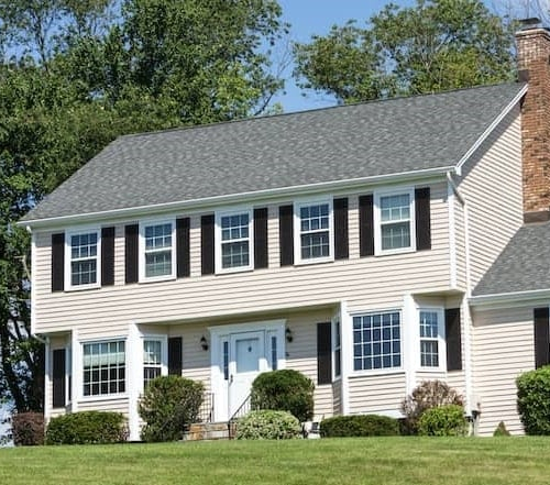 A spacious house with a sizable yard, perfect for outdoor activities and ample space for a large family.