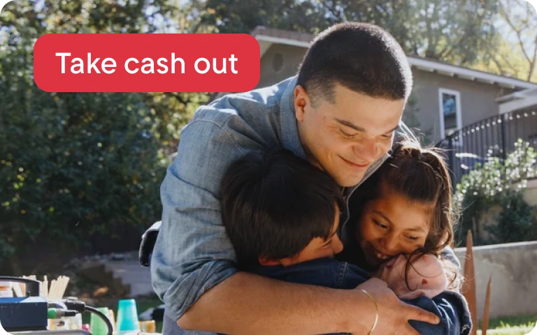 A young man embraces his family members outside of his new home.