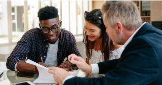 A closing agent explains private mortgage insurance to a pair of home buyers.