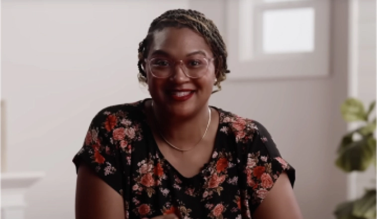 The Red Desk spokeswoman, wearing a floral shirt, can help explain home equity in this video.