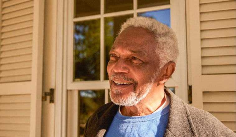 Rocket Mortgage experts help clients like this mature Black man with silver hair understand when to refinance.