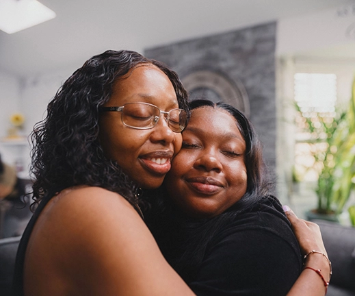 Loan options from Rocket Mortgage can help real estate agents get clients like these two Black women sharing an affectionate hug into the home of their dreams.