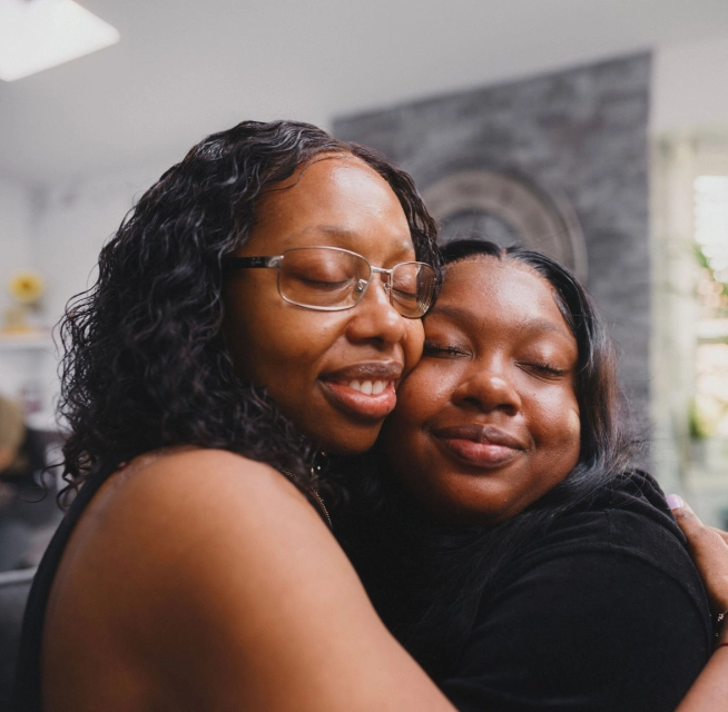 Loan options from Rocket Mortgage can help real estate agents get clients like these two Black women sharing an affectionate hug into the home of their dreams.