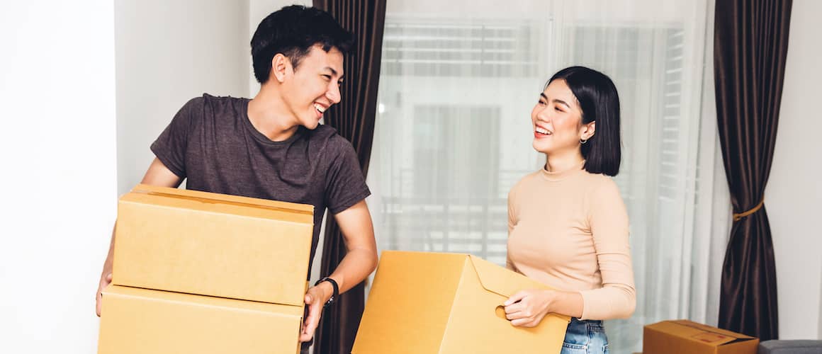 Two friends packing boxes for a move