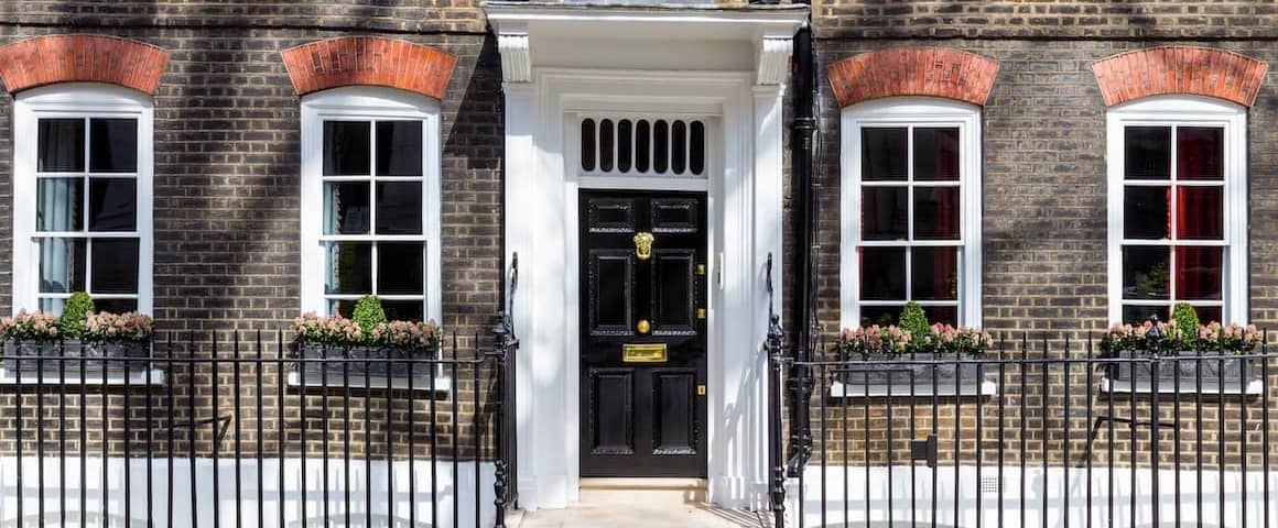 Front entryway with a black door to an apartment.