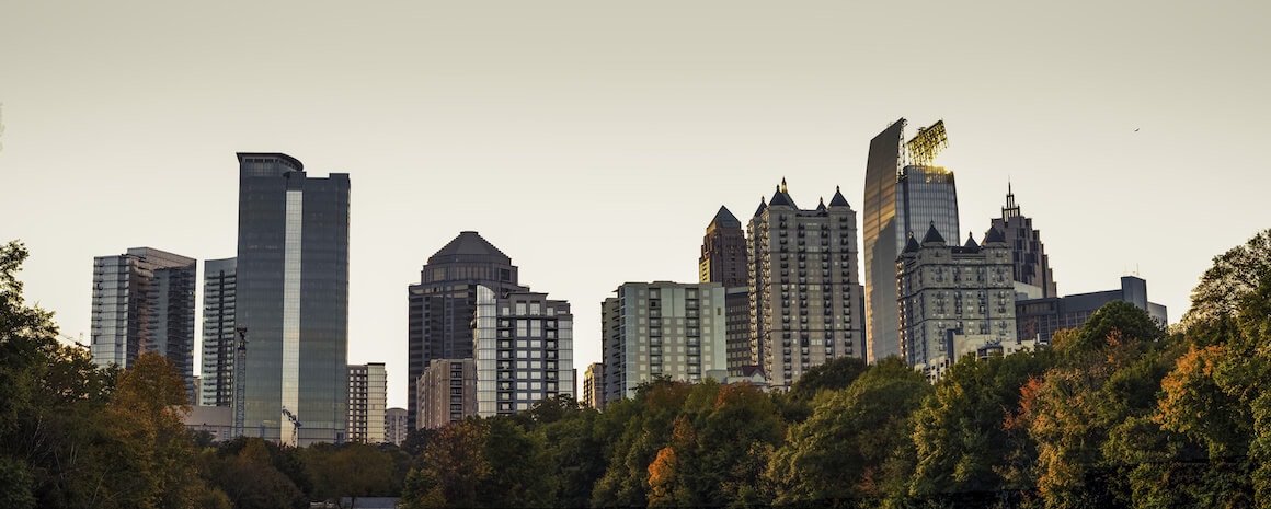 Midtown Atlanta skyline viewed from Piedmont Park, depicting an urban cityscape.