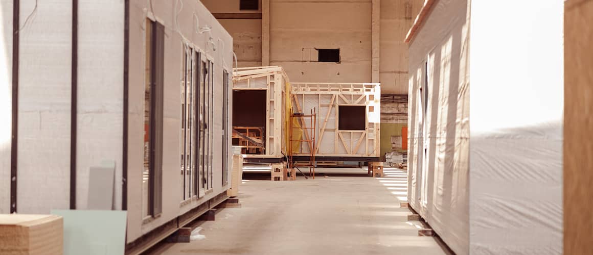 Prefabricated container houses under construction at a building site.