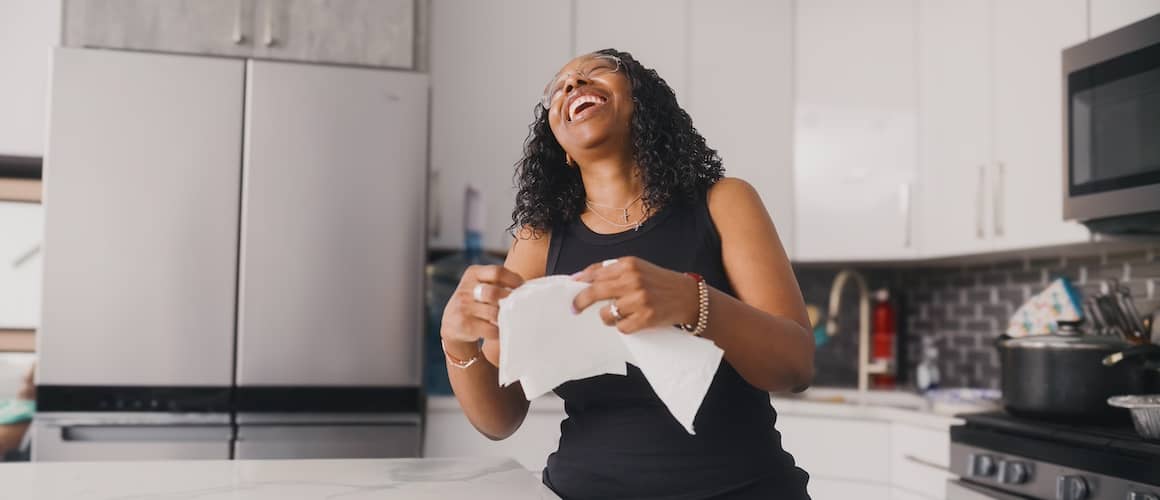 Smiling woman in kitchen.