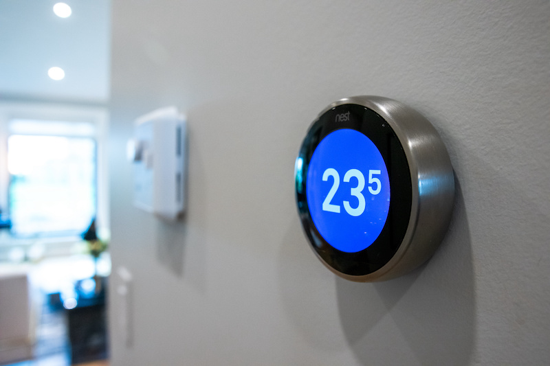 Google Nest Hub mounted on wall showing digital thermometer