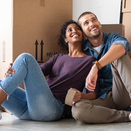 A couple moving into a new home, symbolizing the process of relocation and homeownership.